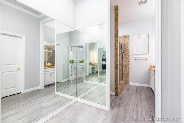 full bathroom with visible vents, crown molding, a stall shower, wood finished floors, and vanity