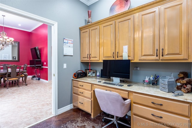 home office featuring baseboards, ornamental molding, built in desk, and a notable chandelier