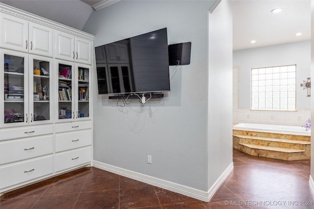 walk in closet featuring dark tile patterned flooring