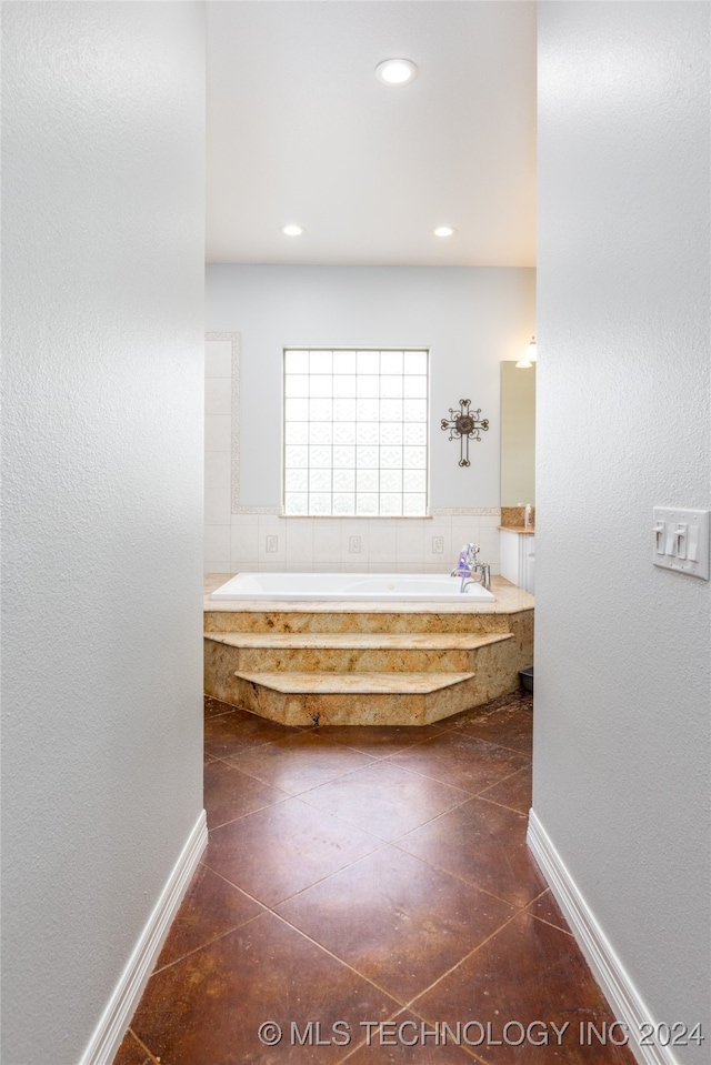 bathroom featuring tile patterned flooring and a bathtub