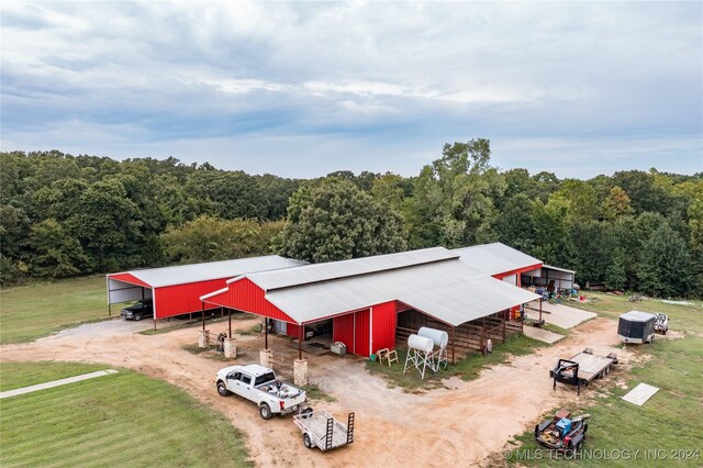 birds eye view of property with a view of trees