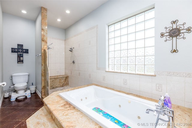 bathroom featuring shower with separate bathtub, toilet, and tile walls