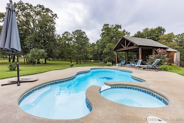 view of swimming pool with a gazebo, a lawn, a patio area, and a pool with connected hot tub