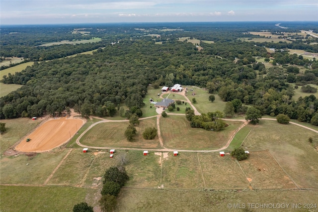 bird's eye view featuring a view of trees and a rural view