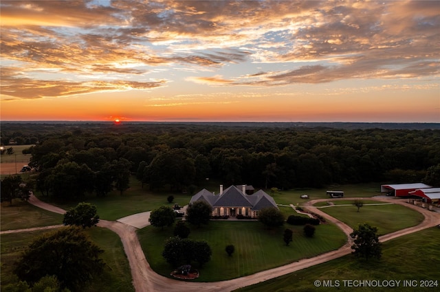drone / aerial view featuring a wooded view