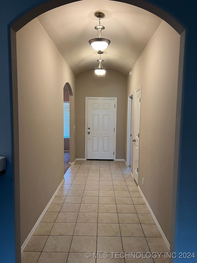 entryway featuring lofted ceiling and light tile patterned flooring