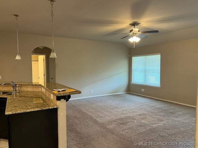 interior space with vaulted ceiling, light colored carpet, sink, and ceiling fan