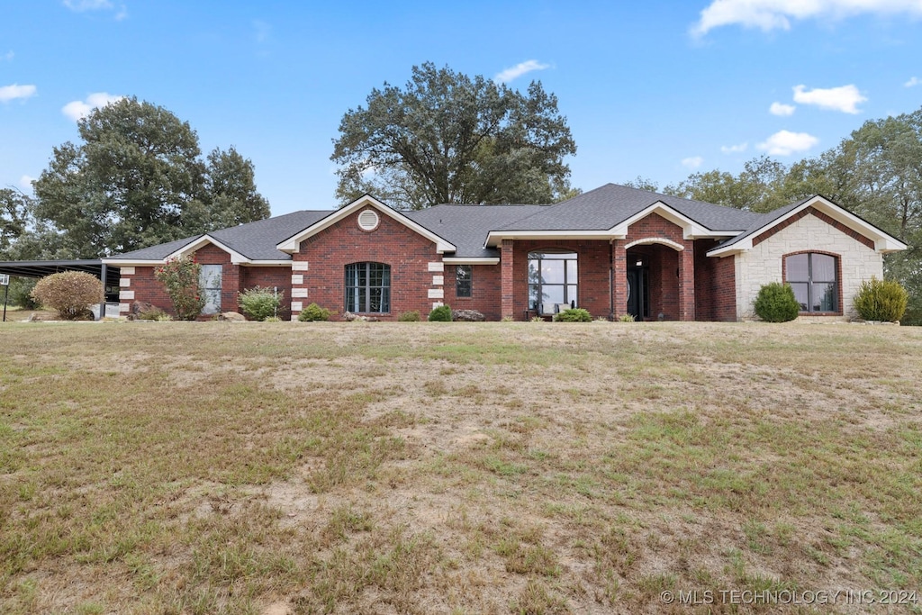 ranch-style home with a front yard