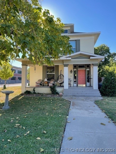 view of front of home featuring a porch and a front lawn