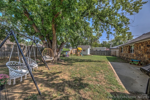 view of yard with a patio area and a playground