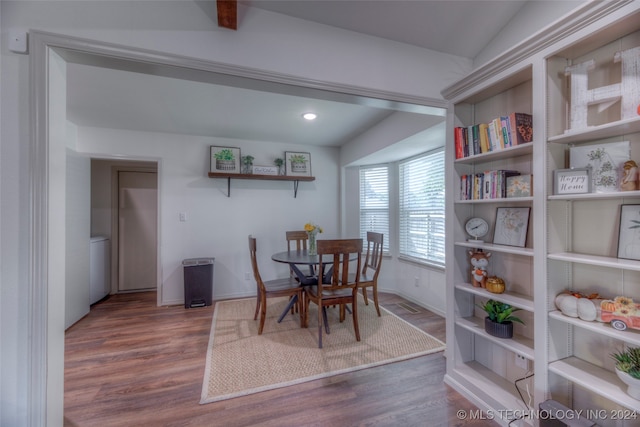 dining area with vaulted ceiling and hardwood / wood-style flooring