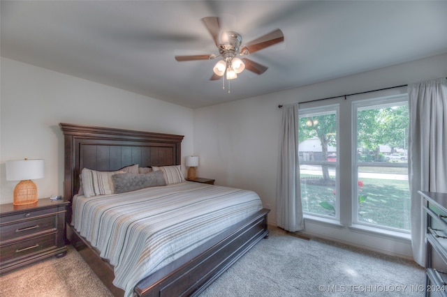 bedroom featuring light colored carpet and ceiling fan