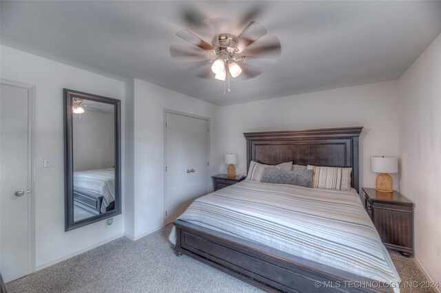 bedroom with ceiling fan and light carpet