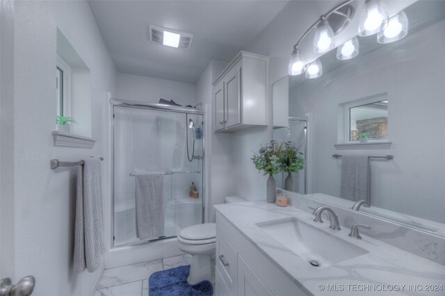 bathroom featuring an enclosed shower, toilet, and vanity