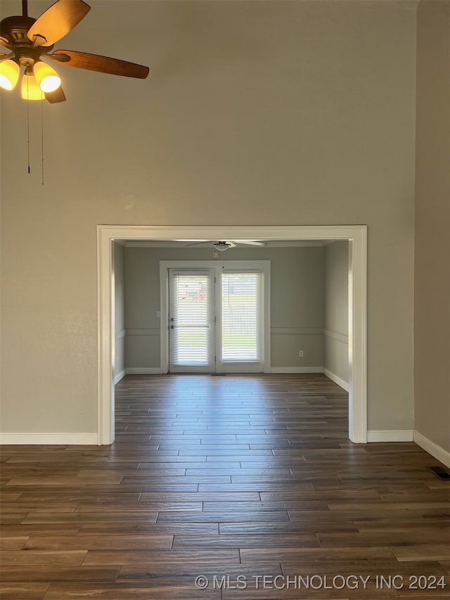 empty room featuring dark hardwood / wood-style flooring and ceiling fan