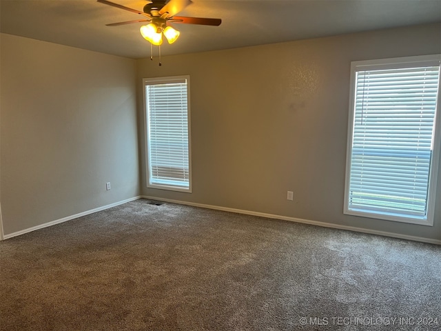 spare room featuring ceiling fan, plenty of natural light, and carpet floors