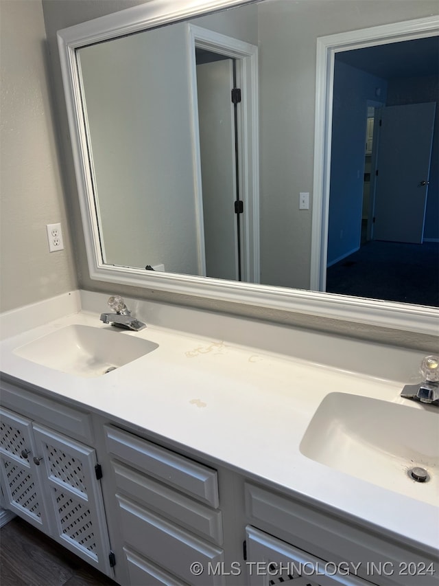 bathroom with hardwood / wood-style floors and vanity