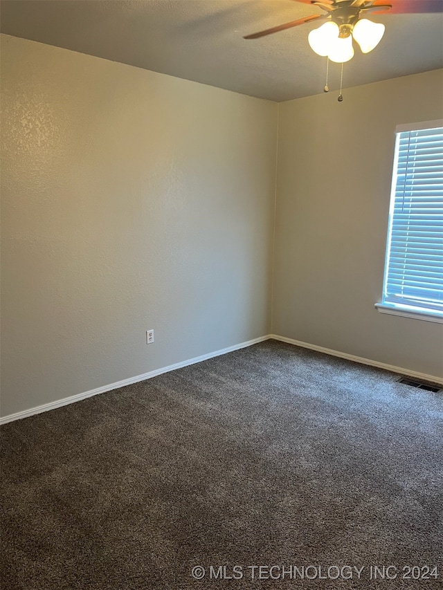 spare room featuring carpet flooring and ceiling fan