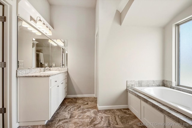 bathroom with a bath and vanity