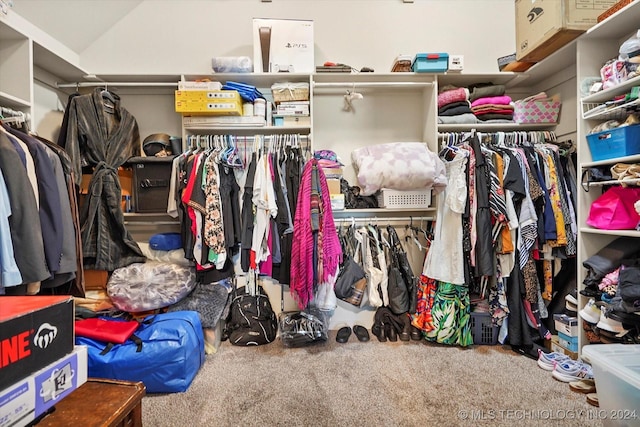 spacious closet featuring carpet and vaulted ceiling