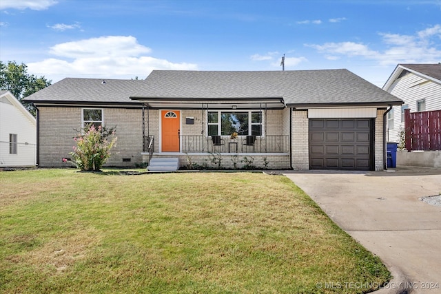 ranch-style home with a front yard and a garage