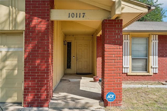 view of exterior entry featuring a garage