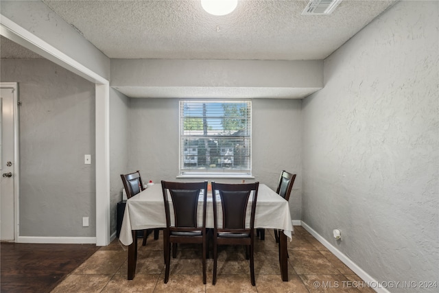 dining room featuring a textured ceiling