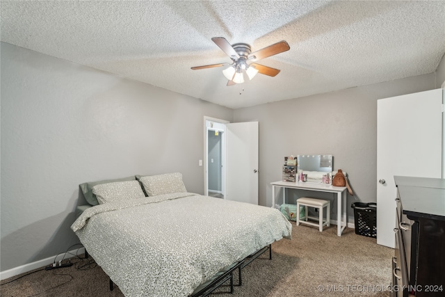 bedroom featuring a textured ceiling, ceiling fan, and carpet