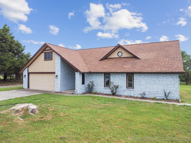 ranch-style house featuring a garage and a front lawn