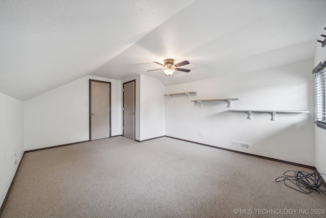 bonus room featuring ceiling fan, light carpet, and vaulted ceiling