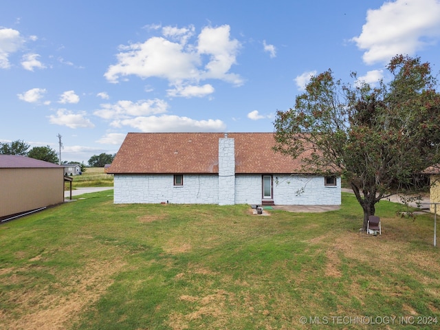 rear view of house with a lawn