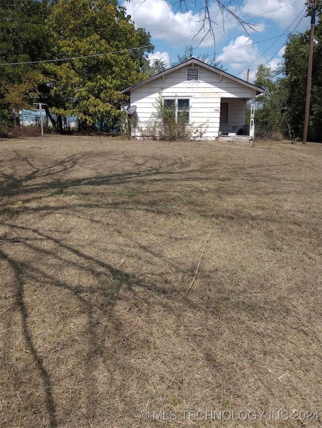 view of property exterior with a yard