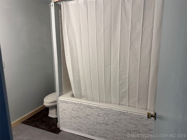 bathroom with toilet, tile patterned floors, and shower / bathtub combination with curtain