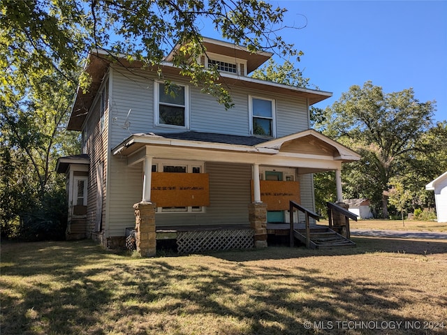 view of front of house with covered porch and a front lawn