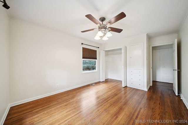 unfurnished bedroom with ceiling fan, ornamental molding, and wood-type flooring