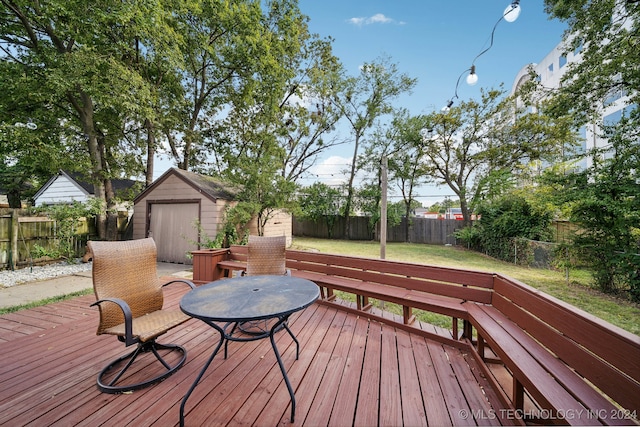 wooden terrace with a storage shed and a yard