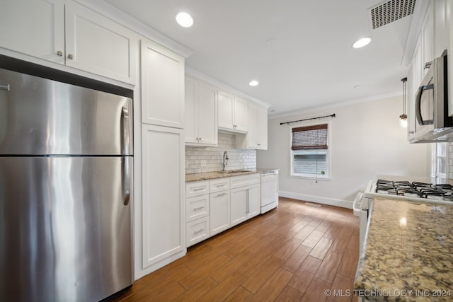 kitchen featuring white cabinetry, dark hardwood / wood-style flooring, sink, light stone countertops, and appliances with stainless steel finishes