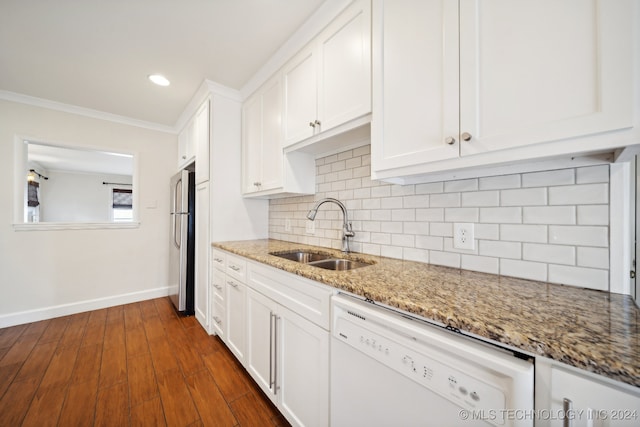 kitchen featuring white cabinets, stainless steel fridge, white dishwasher, and sink