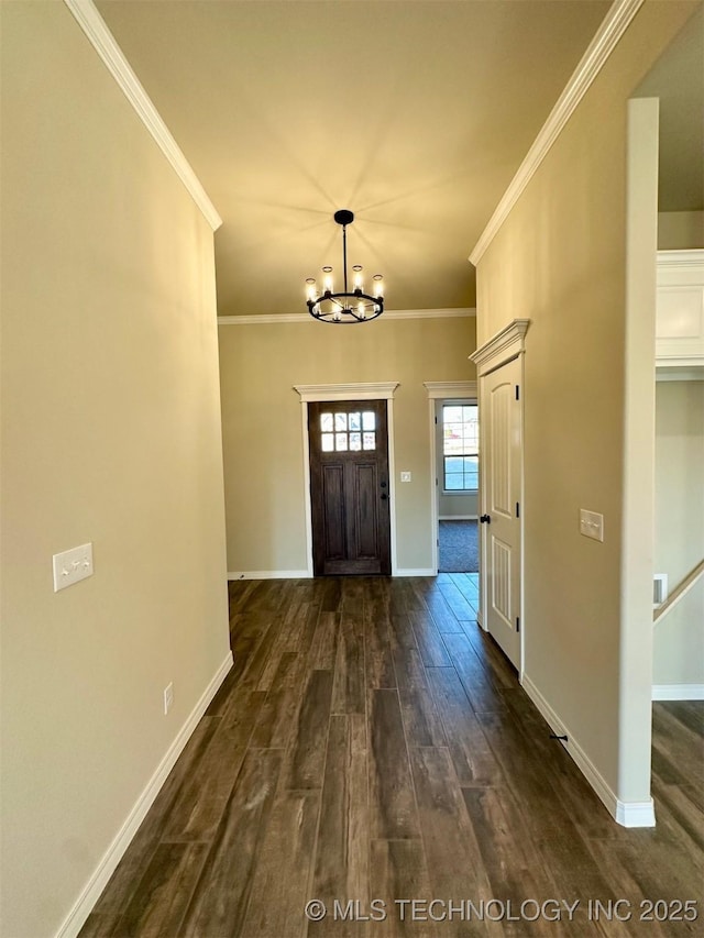 foyer featuring crown molding, dark hardwood / wood-style floors, and a chandelier