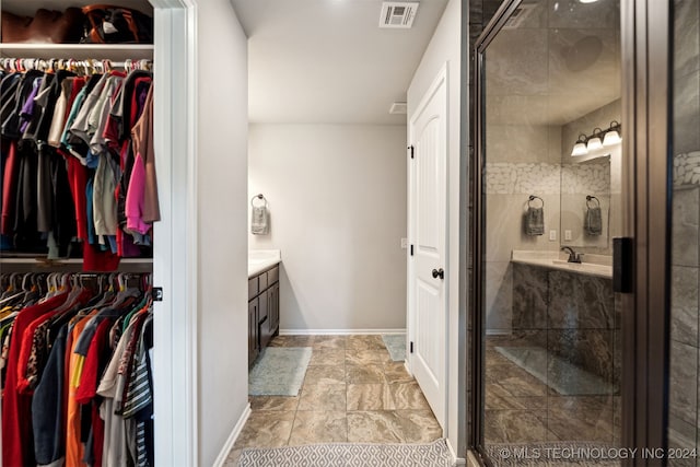 bathroom with walk in shower and vanity