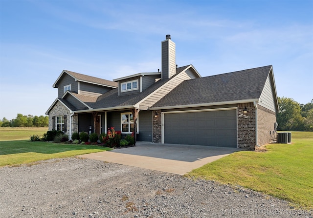 craftsman-style home featuring a front yard, a garage, and central air condition unit