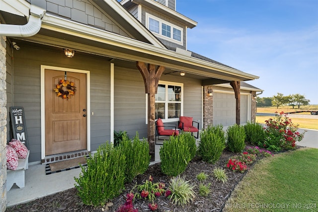 entrance to property with a garage and covered porch