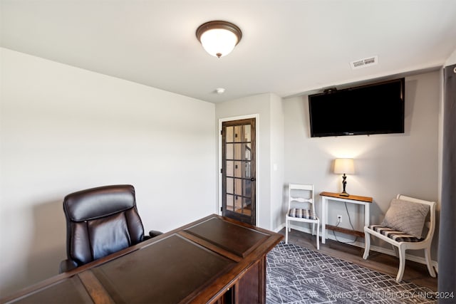 home office with dark hardwood / wood-style floors