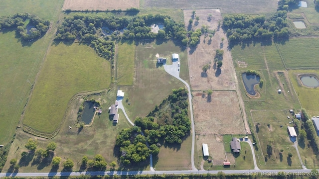 birds eye view of property with a rural view