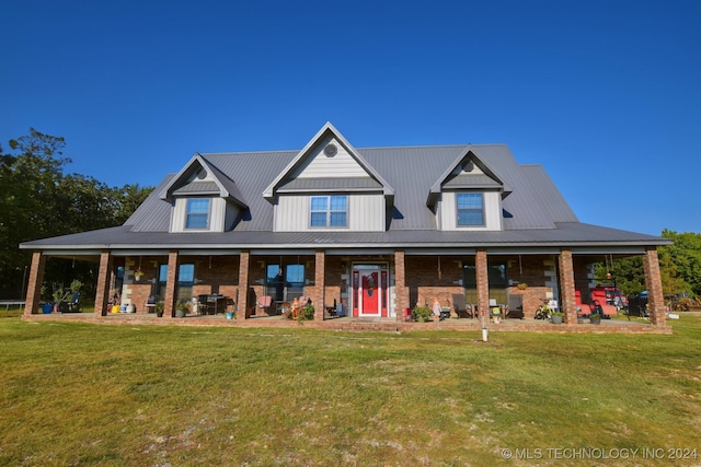 back of property with a yard and covered porch