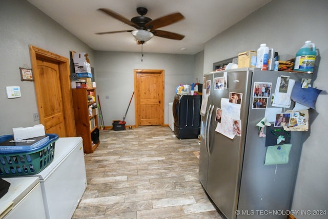 kitchen featuring washing machine and dryer, ceiling fan, stainless steel fridge, and light wood-type flooring