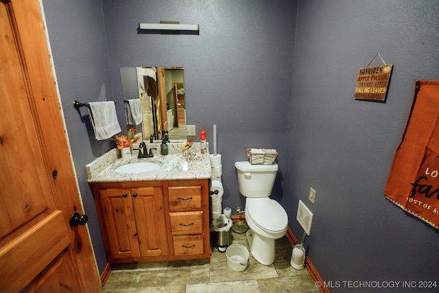 bathroom featuring toilet and vanity