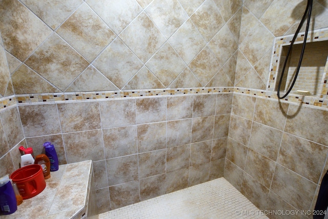 bathroom with a tile shower