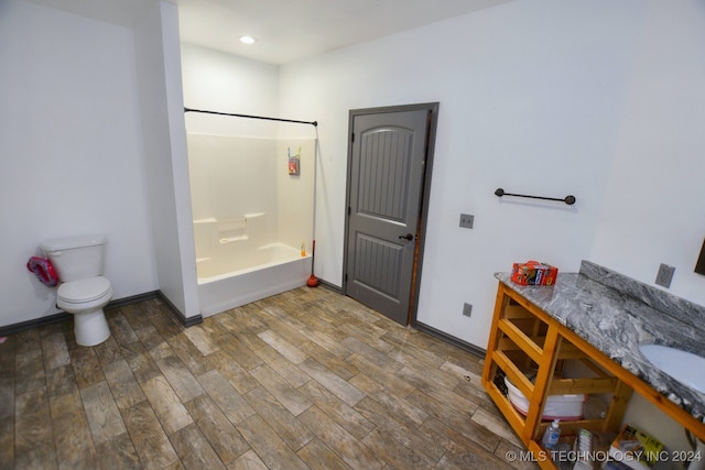 full bathroom with bathtub / shower combination, toilet, hardwood / wood-style flooring, and vanity