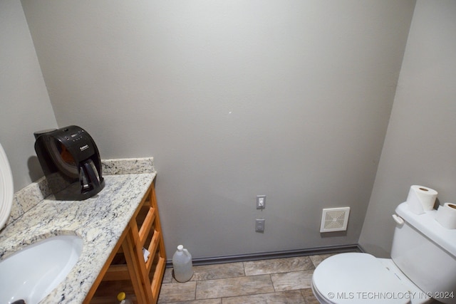 bathroom featuring toilet and vanity